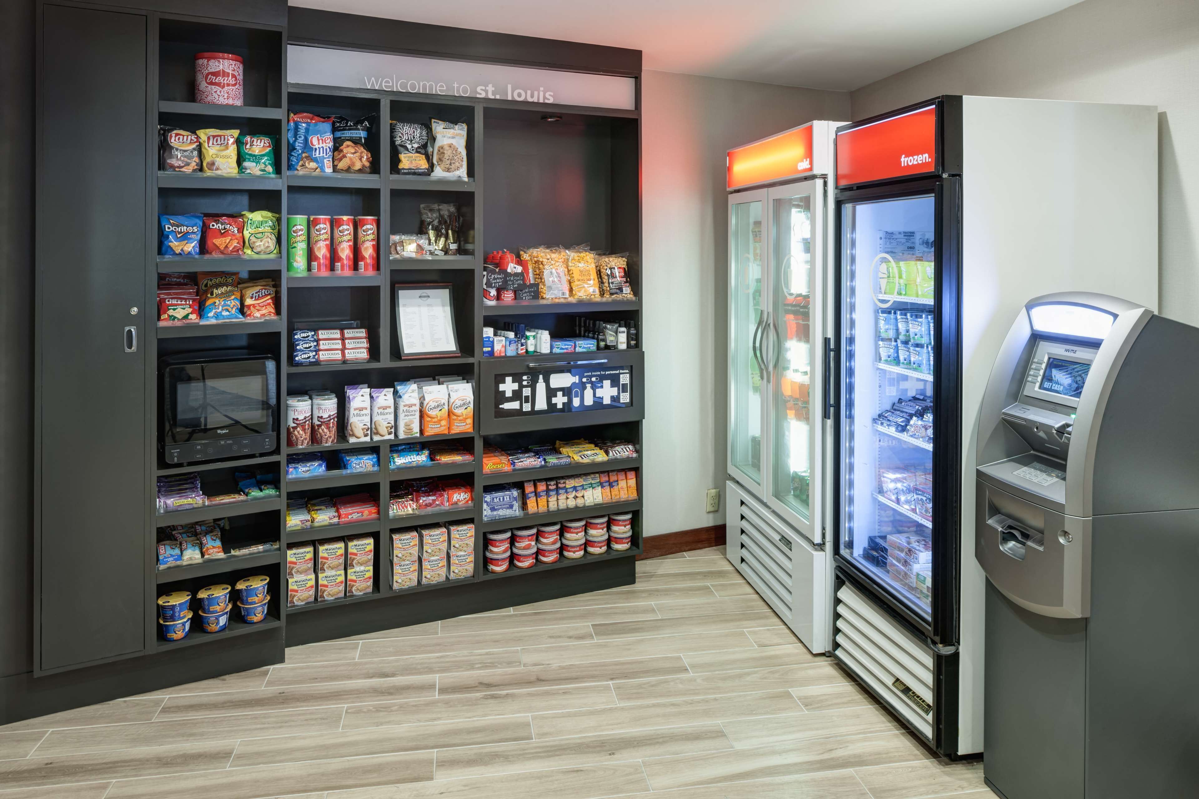 A self-service snack and beverage kiosk with a variety of snacks and frozen drinks.
