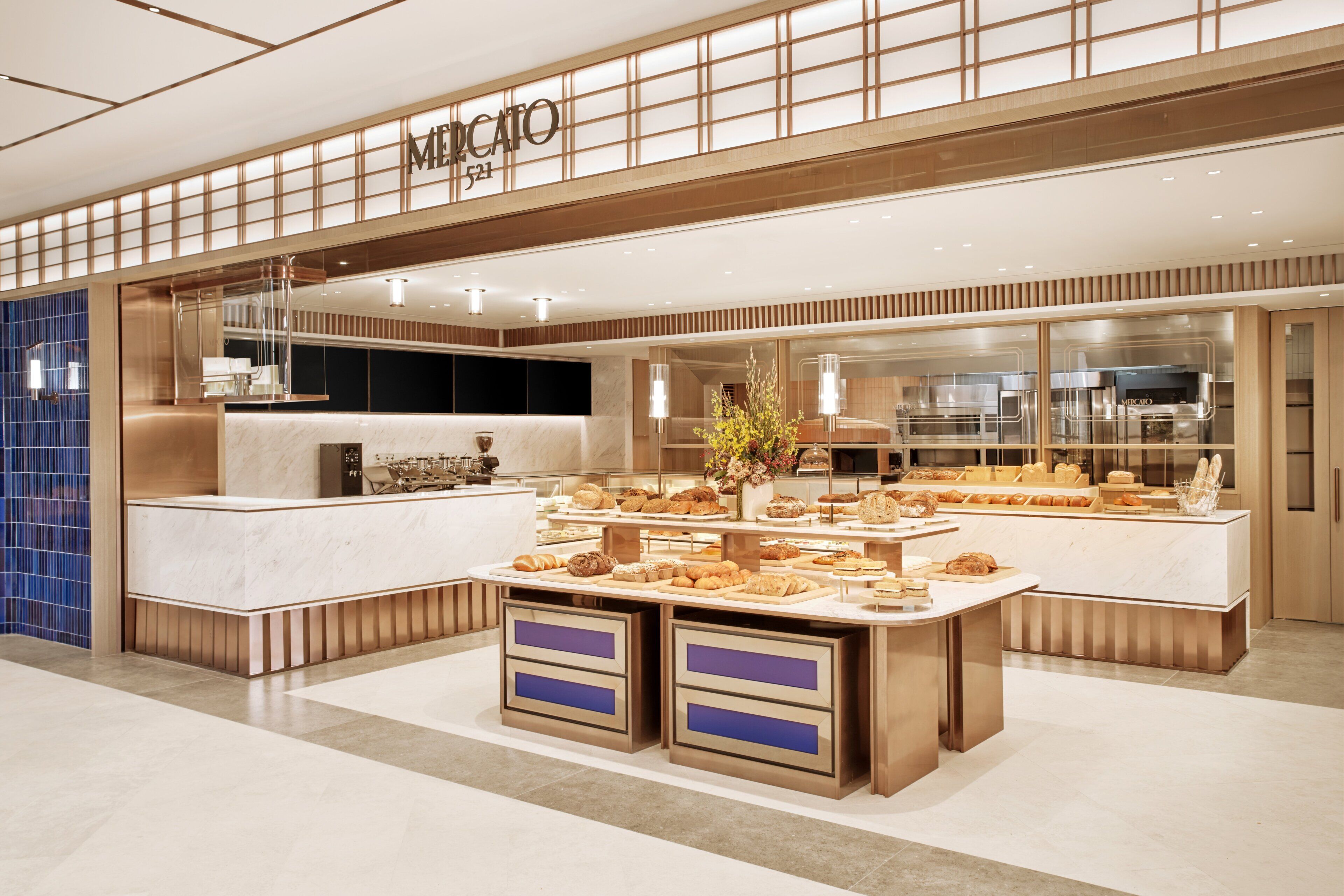 A bakery with a marble counter and display cases filled with pastries.