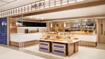 A bakery with a marble counter and display cases filled with pastries.
