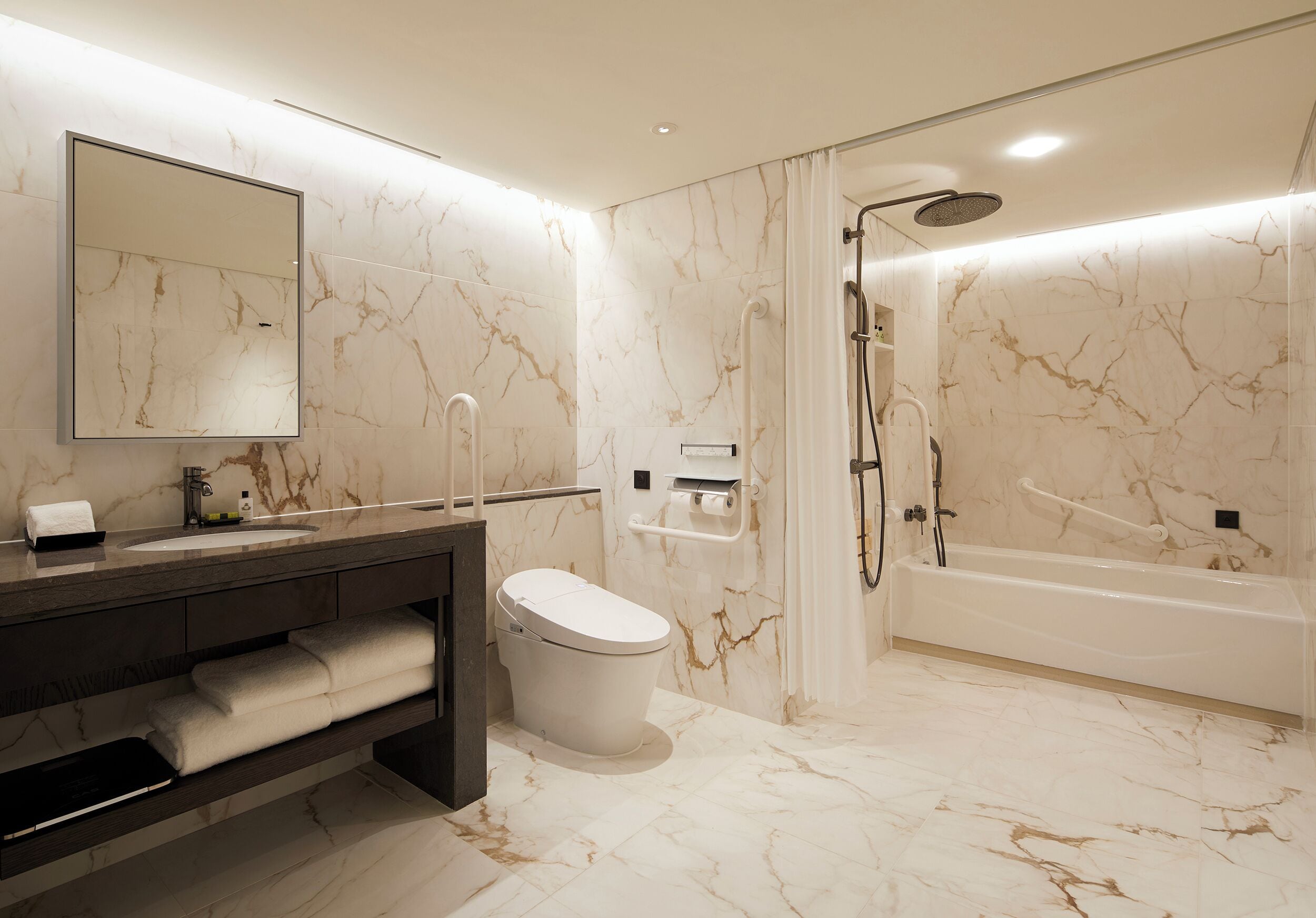A modern bathroom with a marble floor, a toilet, a sink with a vanity, a bathtub, and a shower.