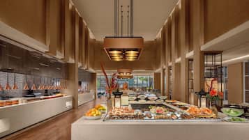 A spacious buffet area with a variety of food options, modern lighting fixtures, and a clean, contemporary design.