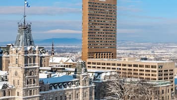 A historic building with a clock tower and a modern high-rise building in the background.