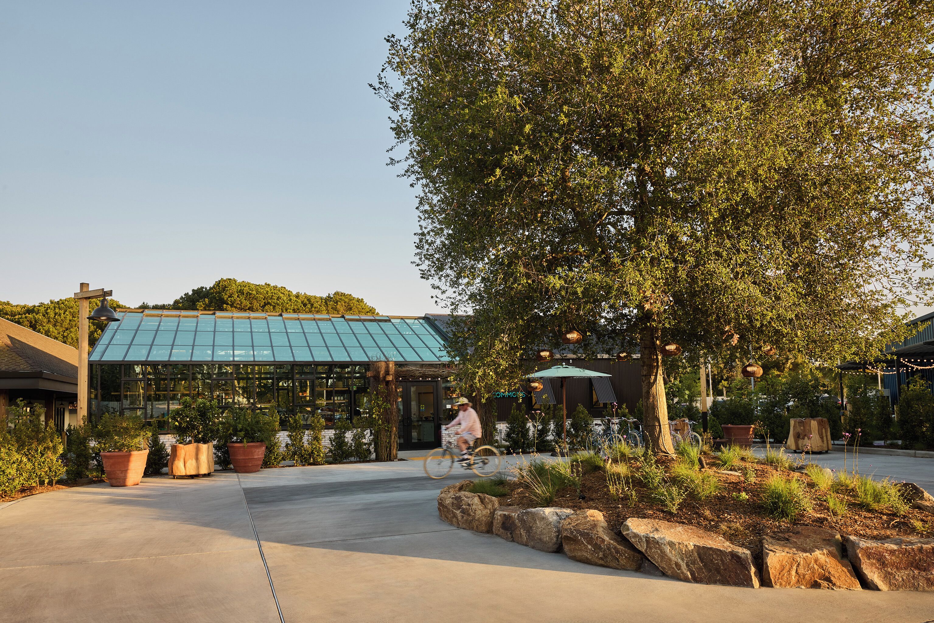 A building with a glass facade and a covered patio area.