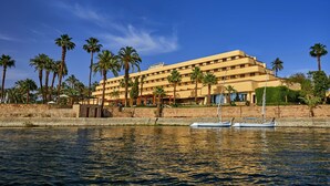 A large, multi-story hotel with a flat roof and a sign reading "Hotel".