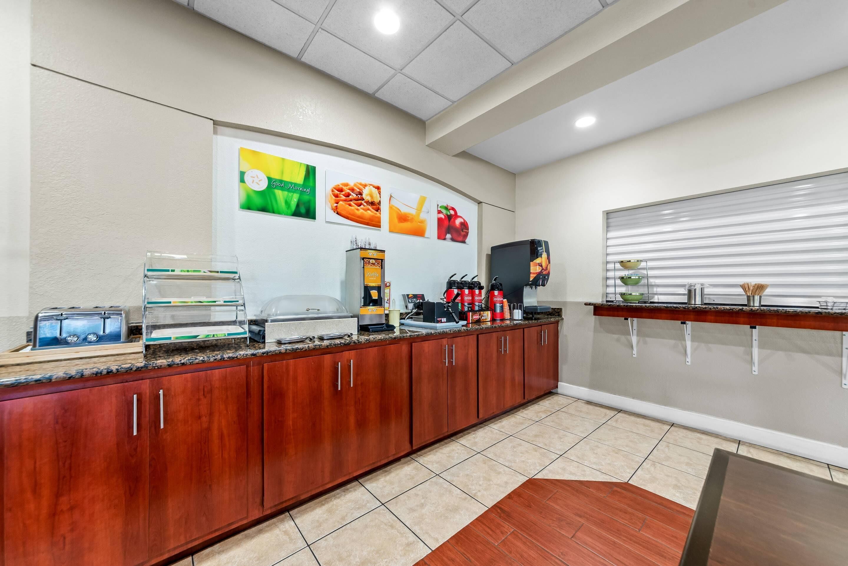 A breakfast bar with a coffee station, a microwave, and a toaster.