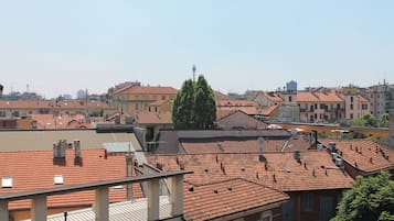 A view of a cityscape with multiple buildings, including a prominent tower in the distance.