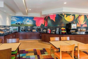 A modern kitchen with a mural, buffet, and seating area. - Fairfield Inn & Suites Mansfield Ontario (Mansfield)