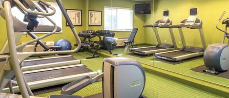 A gym with treadmills, elliptical machines, and weight machines.