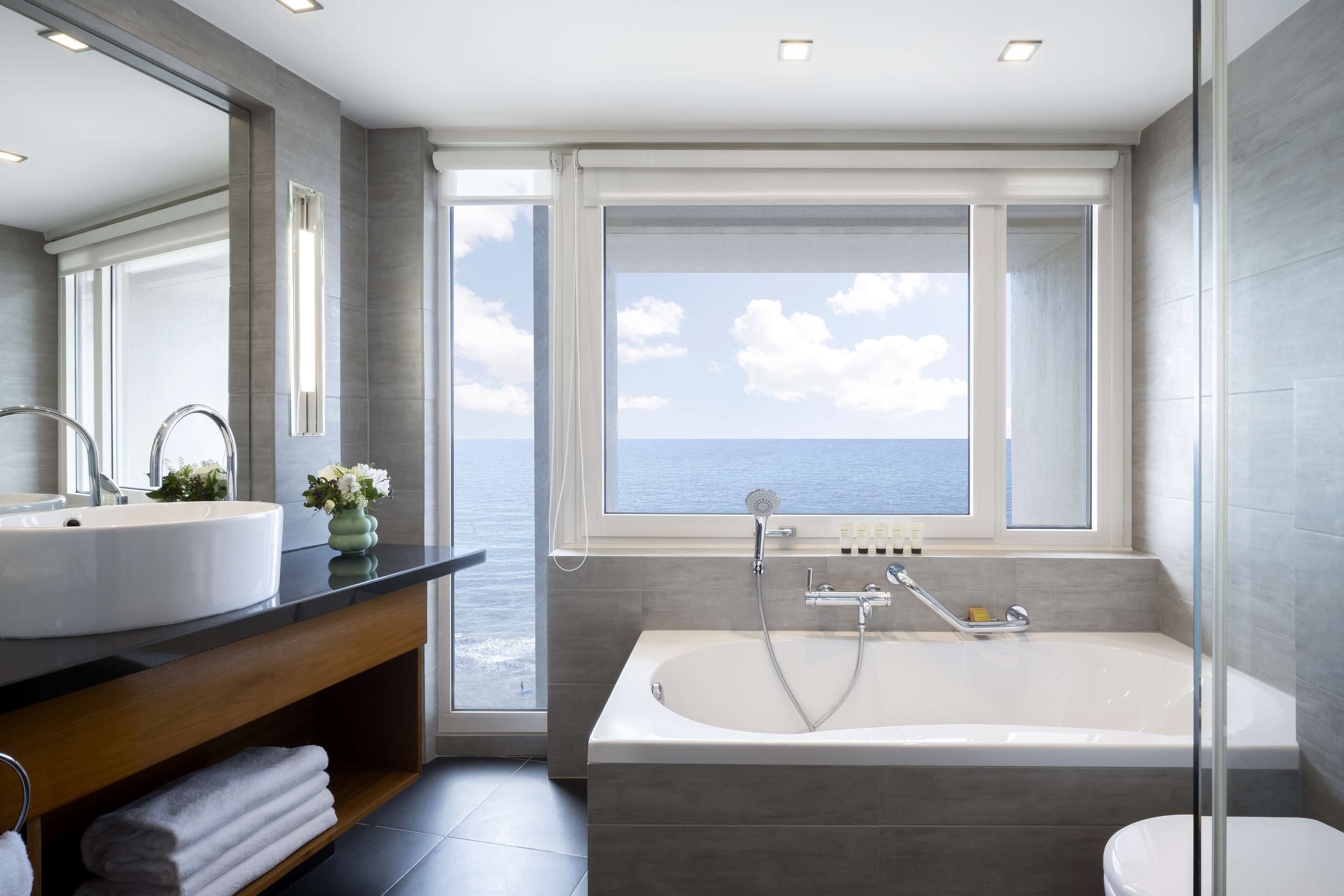 king corner sea view suite | bathroom | separate bathtub and shower, deep-soaking bathtub, designer toiletries