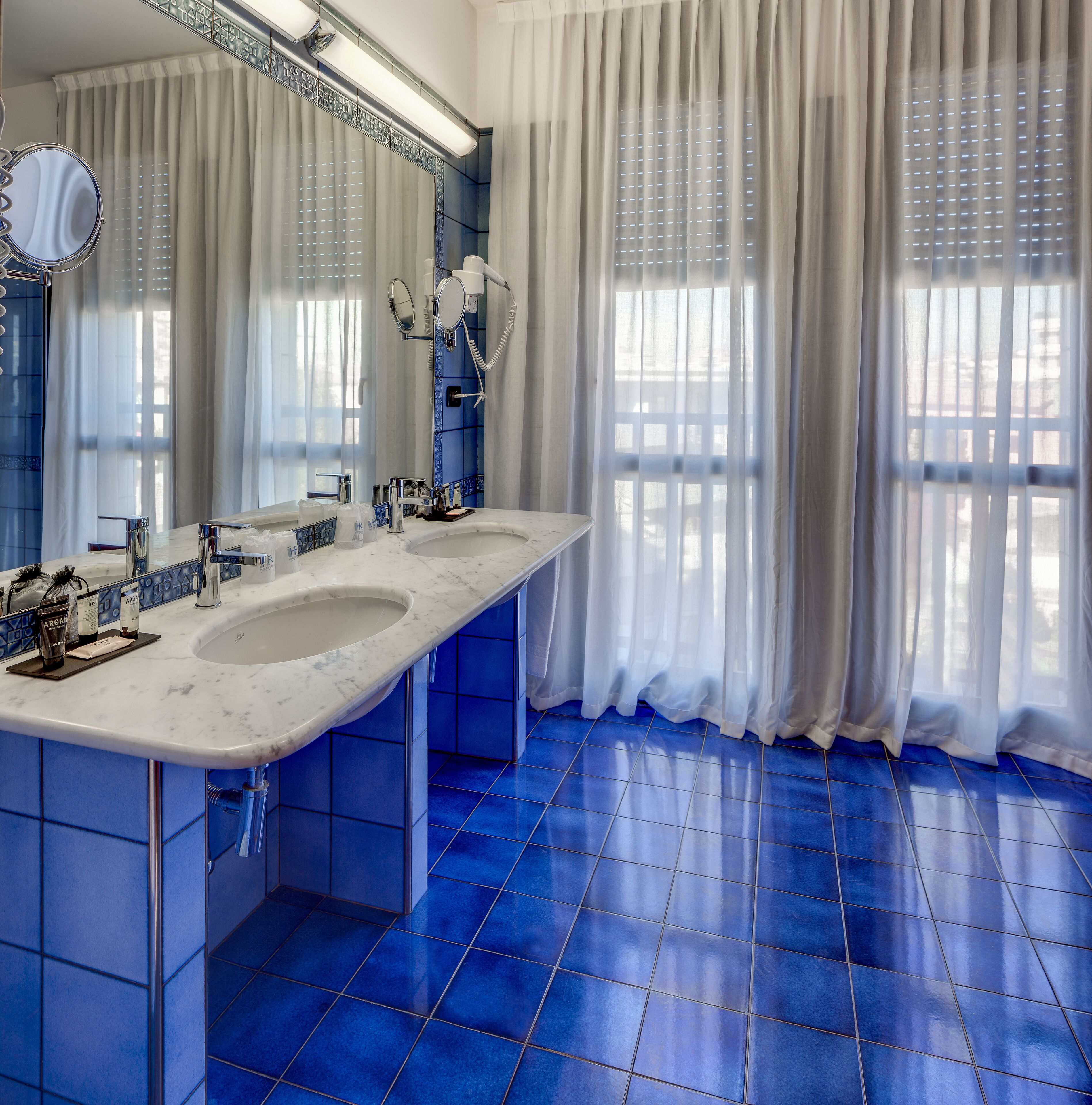 rainfall showerhead, designer toiletries, hair dryer, slippers