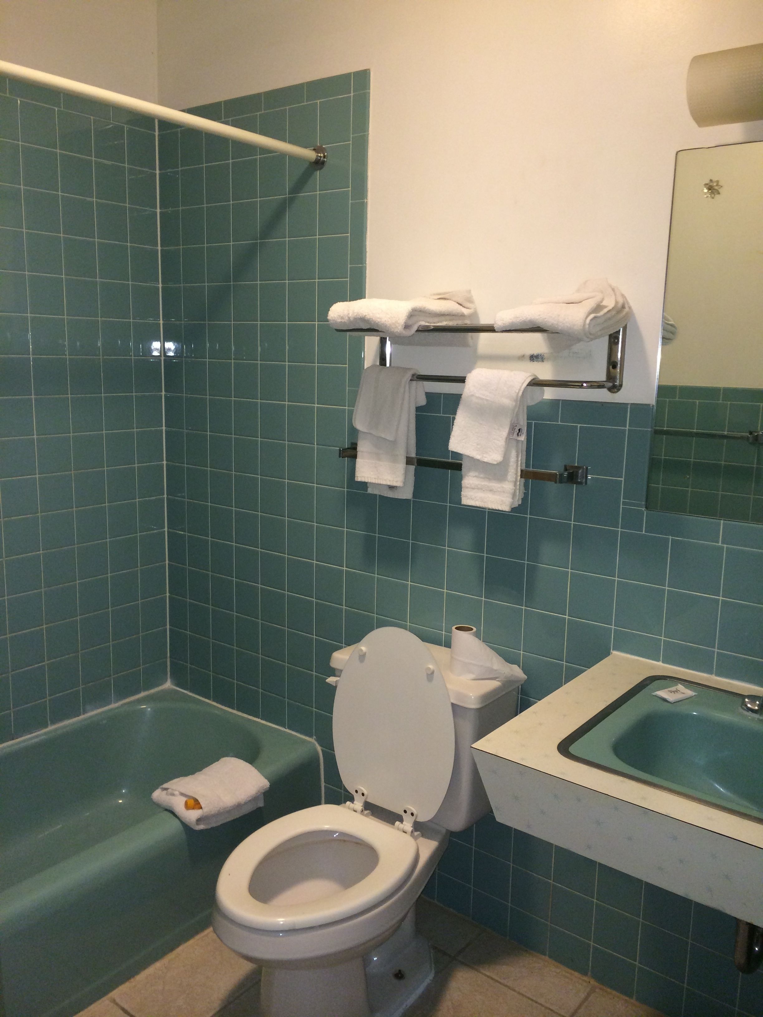 Un bagno con vasca, servizi igienici e lavandino.
