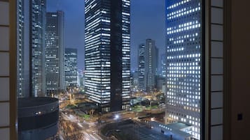 Een stadsgezicht 's nachts met hoge gebouwen en een drukke kruising.