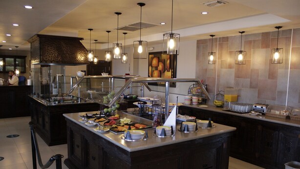 A buffet area with various food items and a counter.