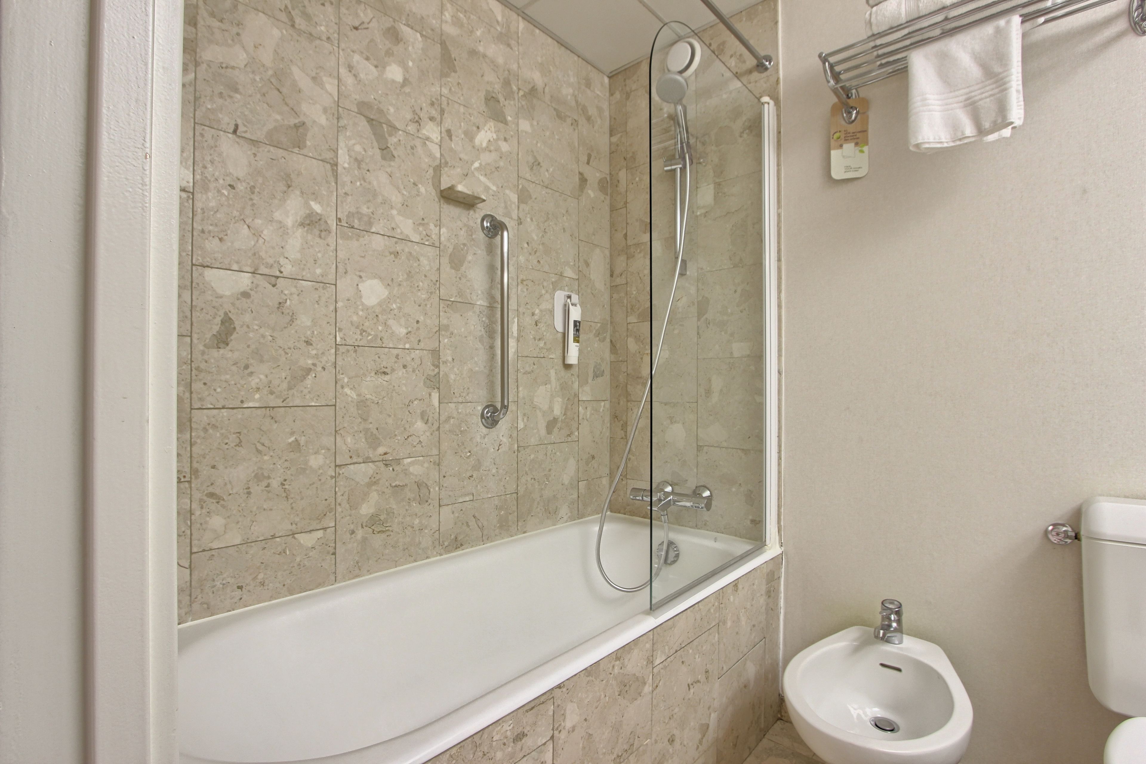 bathtub, eco-friendly toiletries, hair dryer, bidet