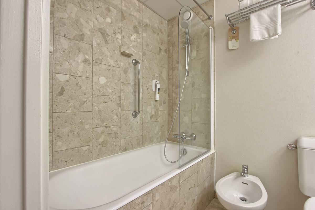 bathtub, eco-friendly toiletries, hair dryer, bidet