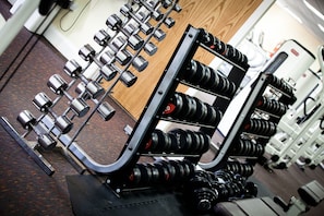 A gym with weightlifting equipment, including dumbbells and barbells. - Lancaster House Hotel (Lancaster)