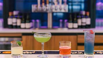 A bar area with four different cocktails.