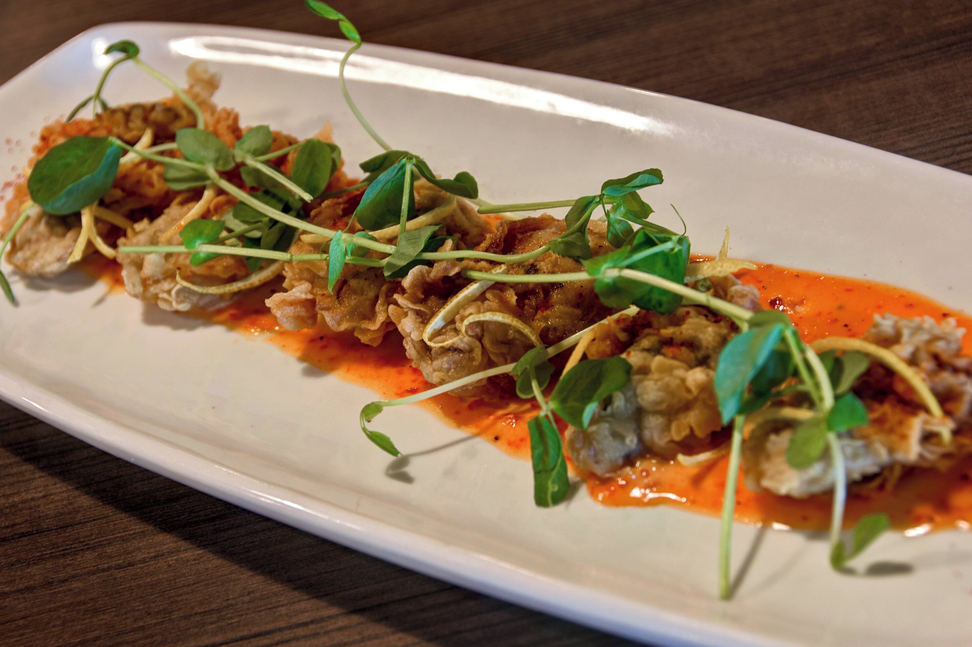 A white rectangular plate with a food arrangement.