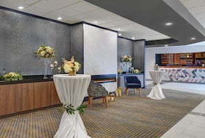 A hotel lobby with a reception desk, seating area, and a bar. - Holiday Inn Philadelphia-Cherry Hill by IHG (Cherry Hill)