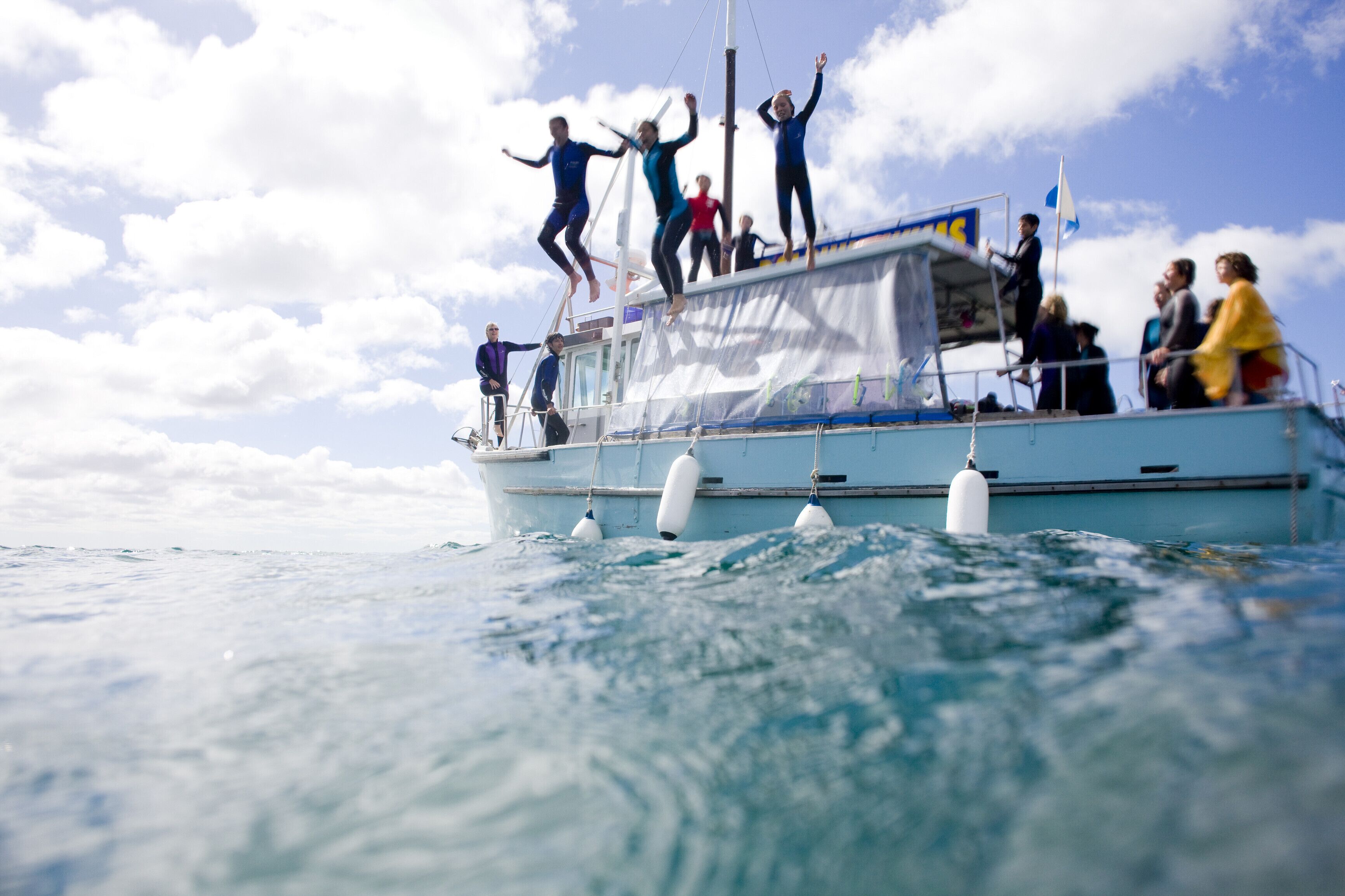 People on a boat with a clear sky in the background.