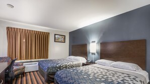 A hotel room with two beds, a desk, and a chair. - Econo Lodge Milwaukee Airport (Milwaukee)