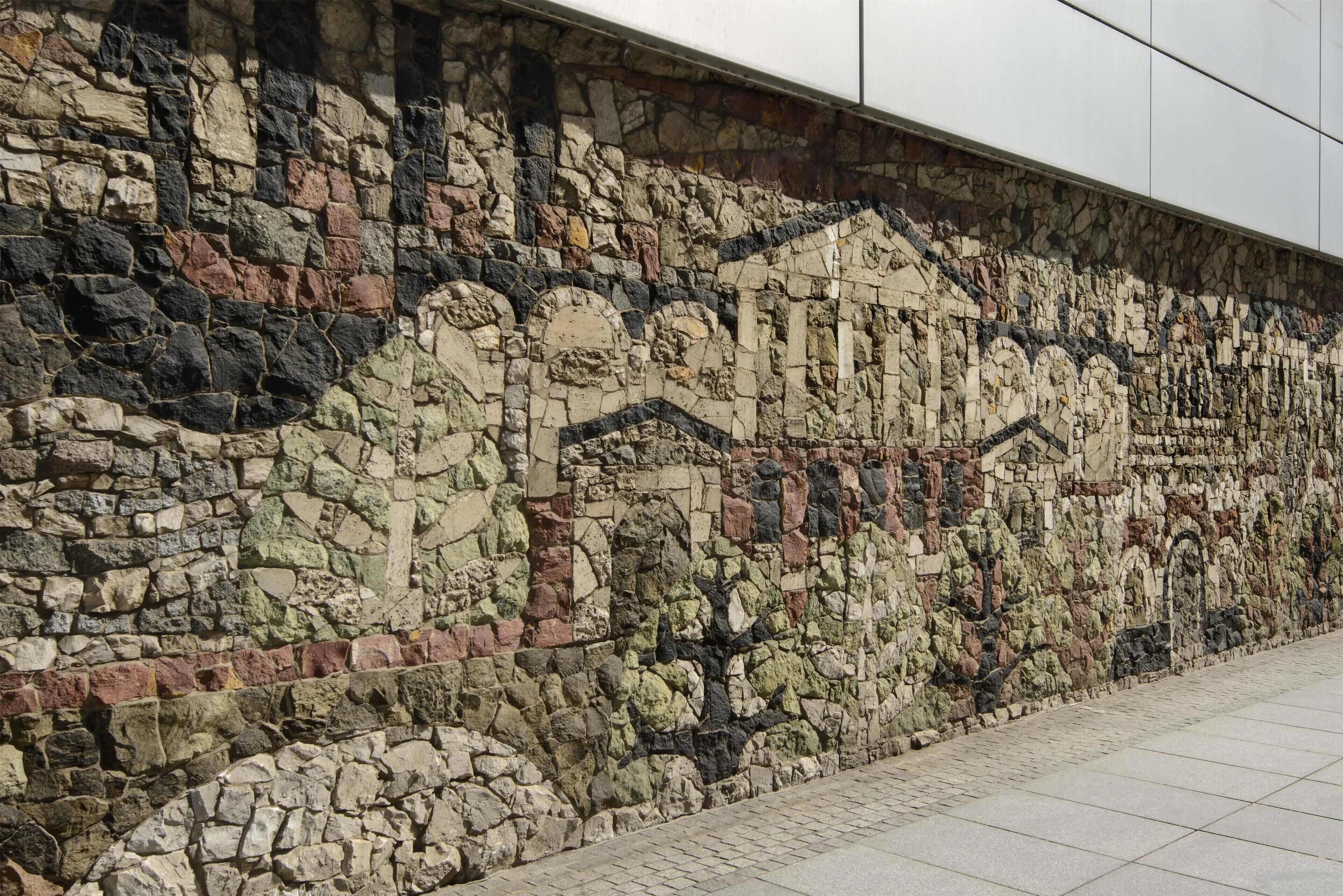 A stone wall with a mosaic pattern.