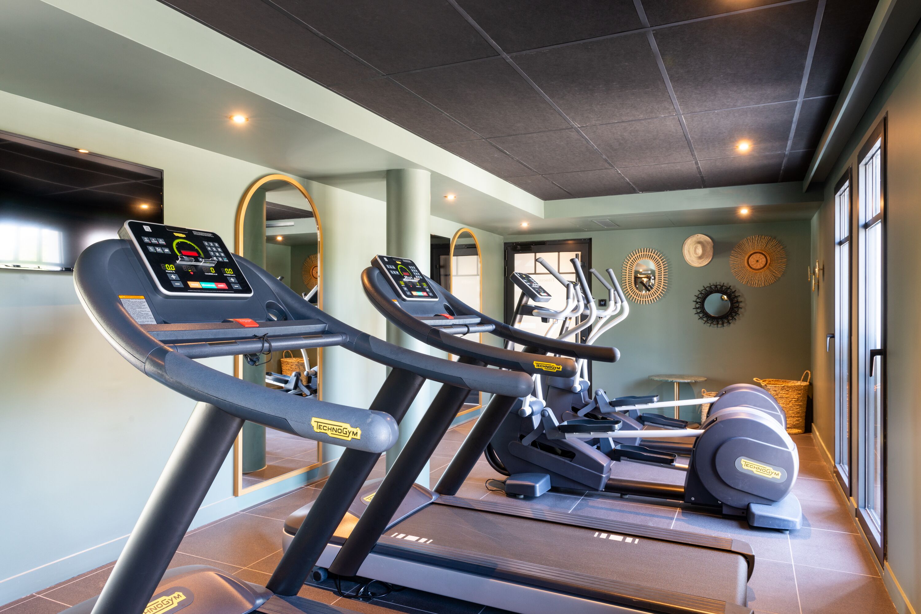 A gym with treadmills and exercise equipment.
