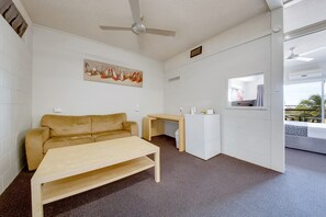 Deluxe Queen Room | Living area | 26-inch TV with digital channels