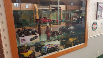 A display case with various model vehicles, including a GMC 18-Wheeler and a vintage car.