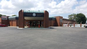 A building with a sign for Route 66 and a hotel sign indicating it's open now. - Route 66 Hotel, Springfield, Illinois (Springfield)