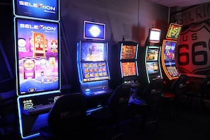 A row of slot machines with illuminated screens, one prominently displaying 'SELEXION' and another with 'Players World'. - Route 66 Hotel, Springfield, Illinois (Springfield)