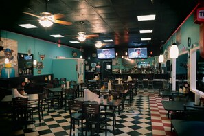 A diner with booths, tables, ceiling fans, and a checkered floor. - Route 66 Hotel, Springfield, Illinois (Springfield)