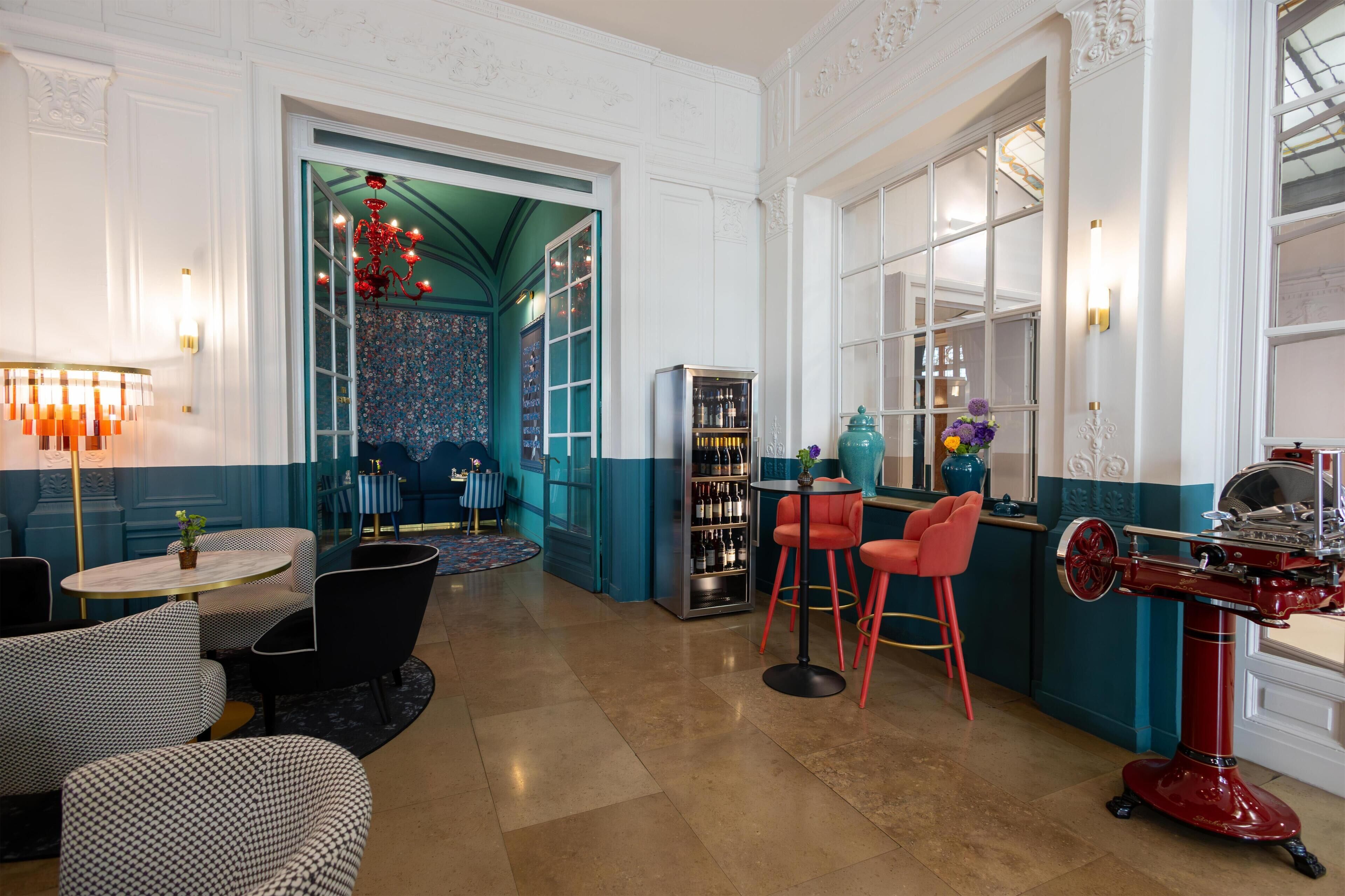 A bar area with seating, a wine cooler, and a decorative ceiling.