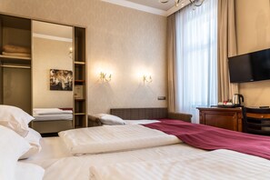 A hotel room with a bed, a wardrobe, a desk with a television, and a window with curtains. - Fuerst Metternich (Vienna)