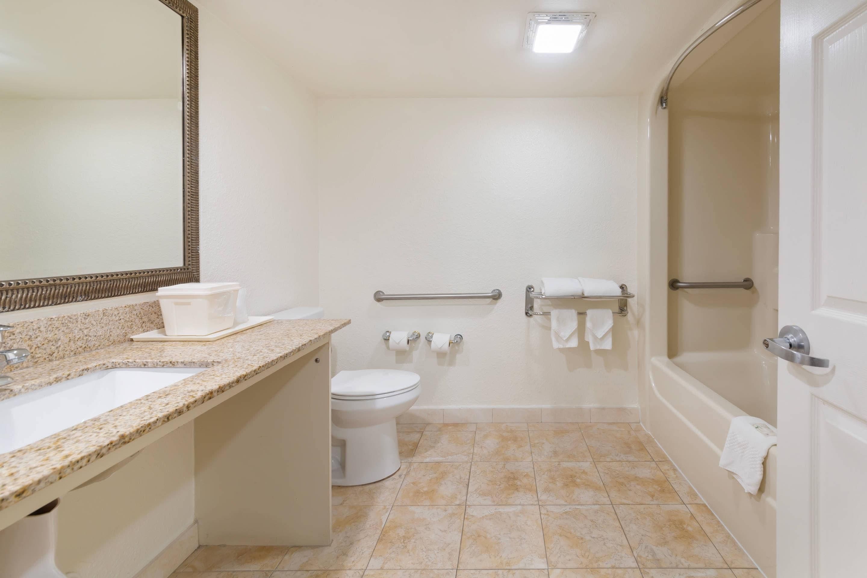 A bathroom with a sink, toilet, and bathtub.