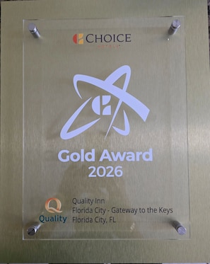 A plaque with the 'Gold Award 2026' text, 'Choice Hotels' logo, and 'Quality Inn' name and location. - Quality Inn Florida City - Gateway to the Keys (Florida City)
