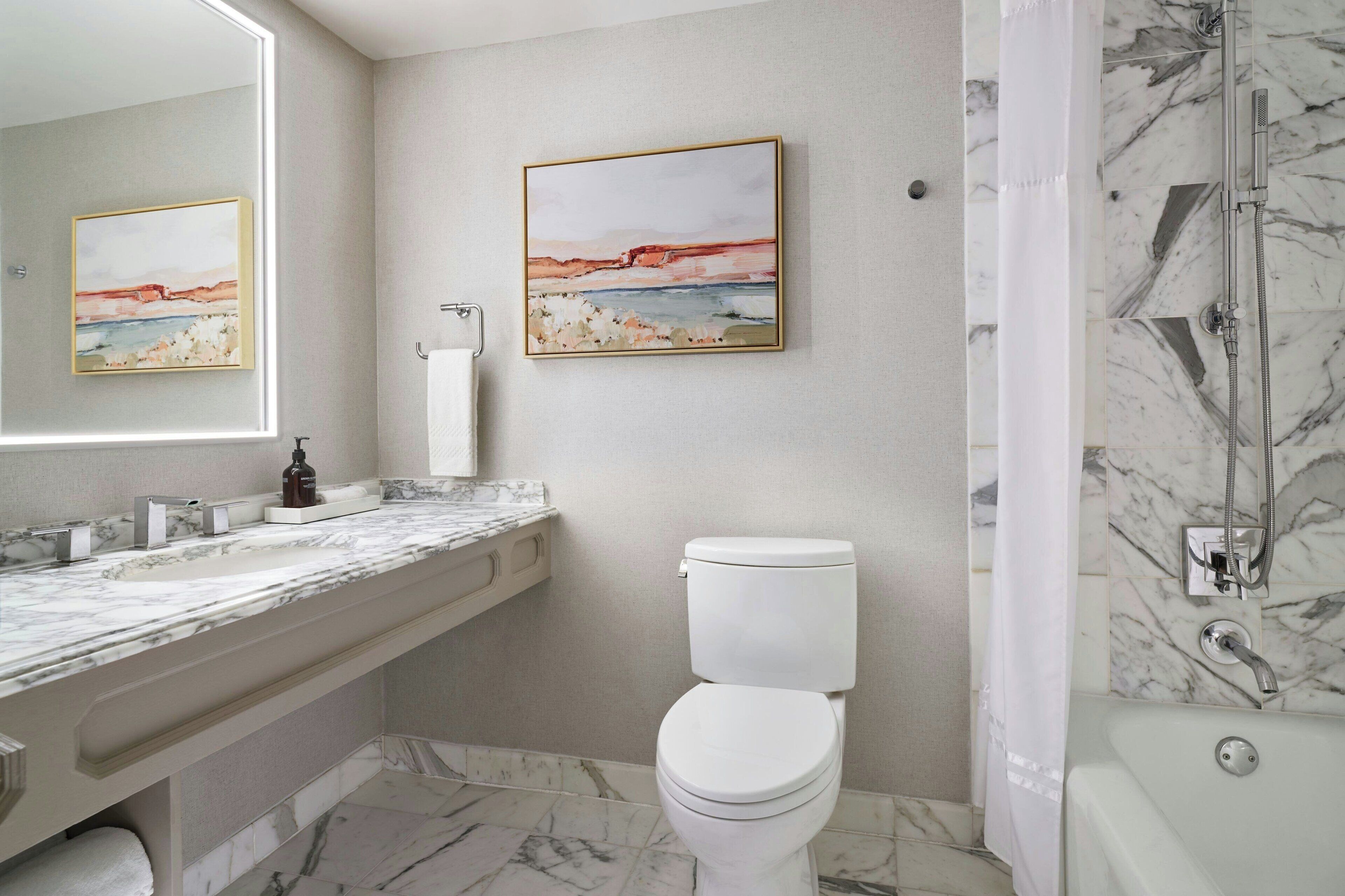 designer toiletries, hair dryer, slippers, towels