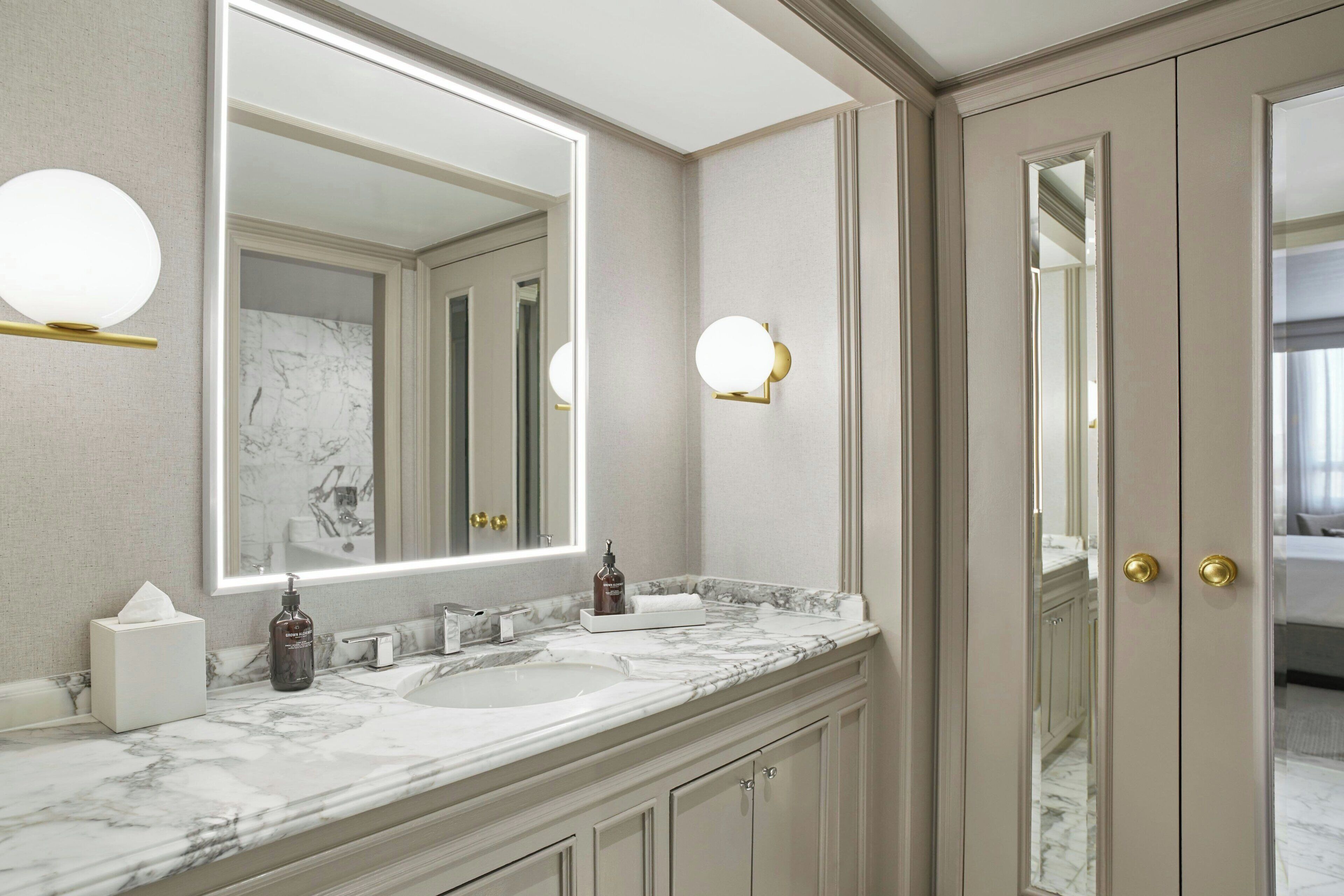 designer toiletries, hair dryer, slippers, towels