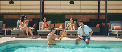 Zona junto a la piscina con sillas de descanso y una alberca.