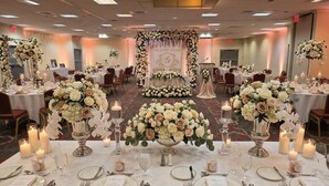 A banquet hall with round tables set for a formal event, featuring floral centerpieces and candles. - Quality Inn Lexington -Horse Park (Lexington)