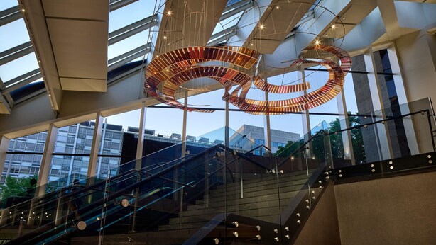 A modern building interior with a spiral staircase, glass railings, and a large, abstract metal sculpture. - Hyatt Regency Washington on Capitol Hill (Washington)