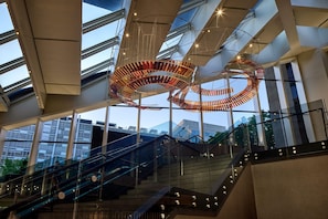 A modern building interior with a spiral staircase, glass railings, and a large, abstract metal sculpture. - Hyatt Regency Washington on Capitol Hill (Washington)