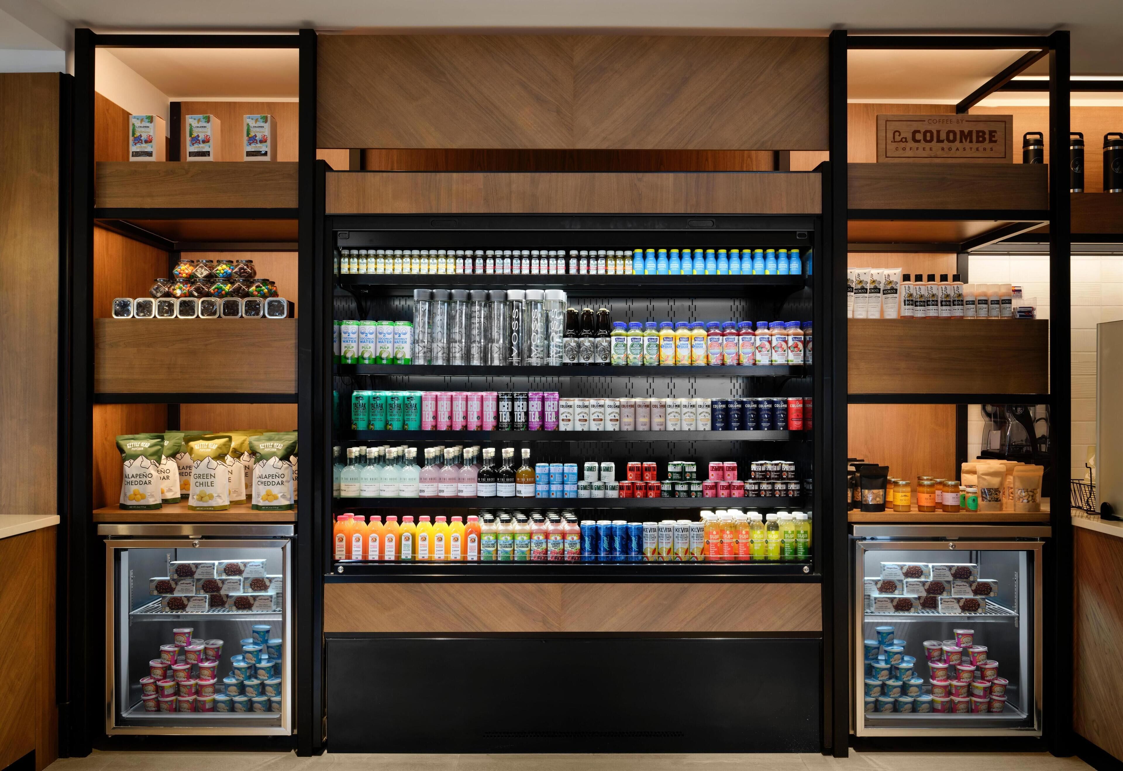 A beverage display with various drinks and snacks.
