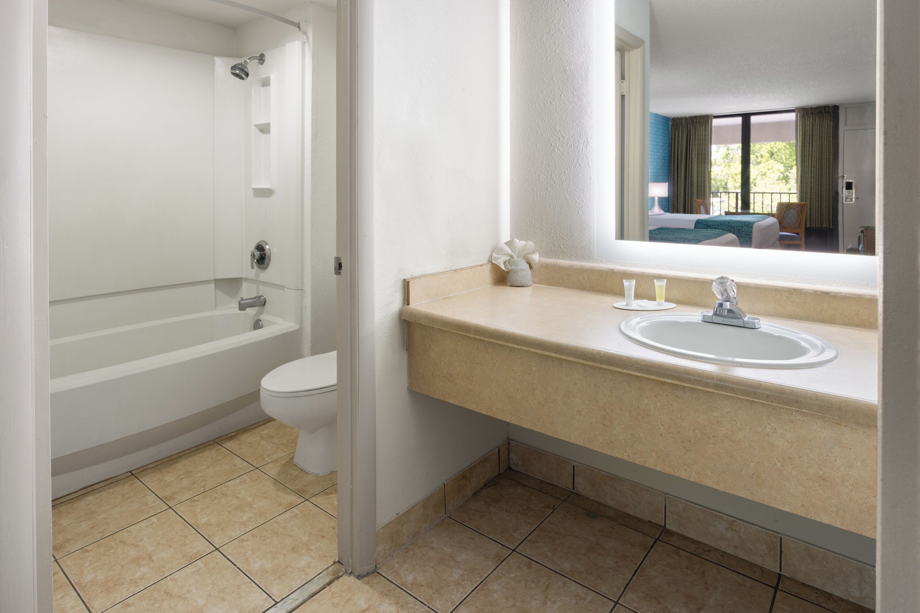 A bathroom with a bathtub, toilet, and sink.