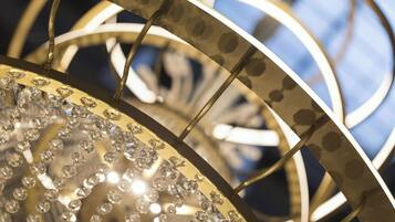 A chandelier with multiple tiers and crystal decorations.
