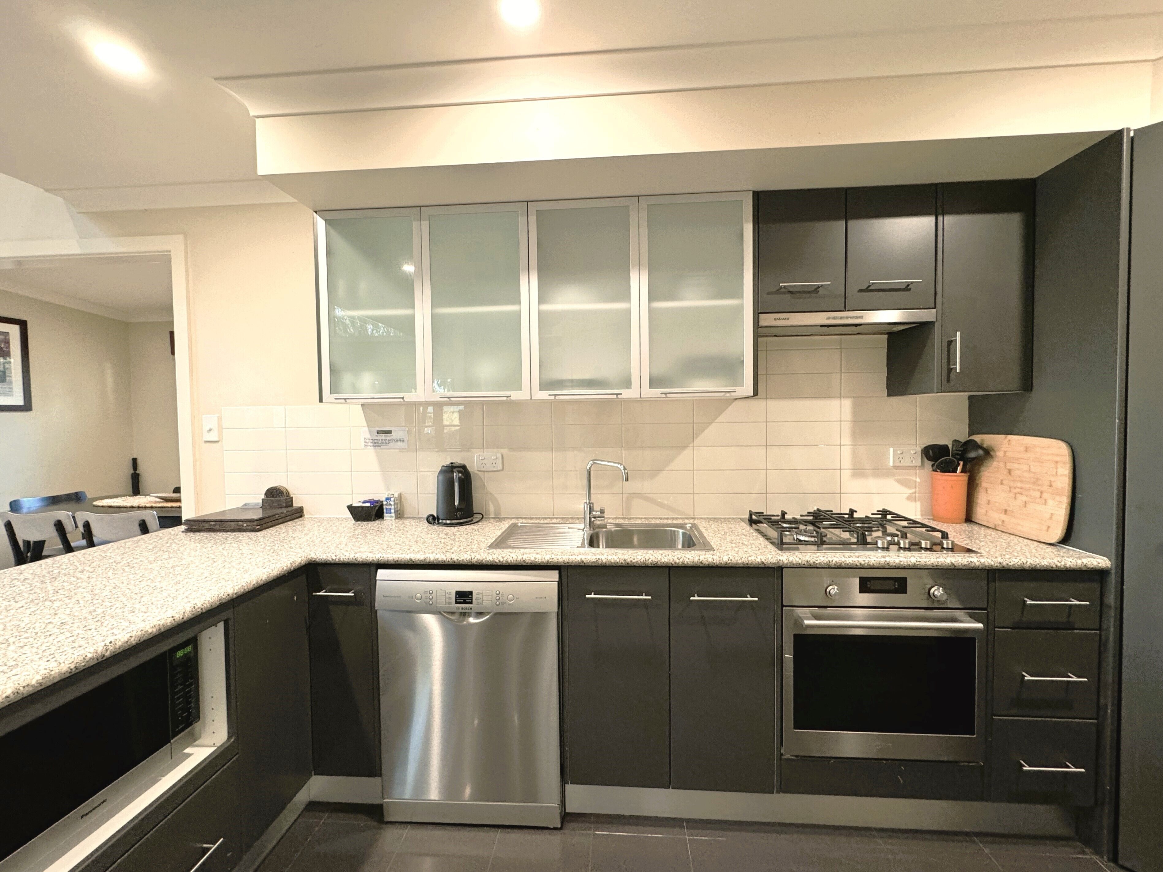 A modern kitchen with stainless steel appliances, a dishwasher, and a gas stove.