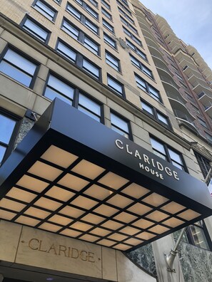 Claridge House features a modern architectural design with a prominent black awning and black-framed windows.