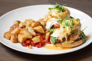 Savor a delicious breakfast with poached eggs, toast, and potatoes.