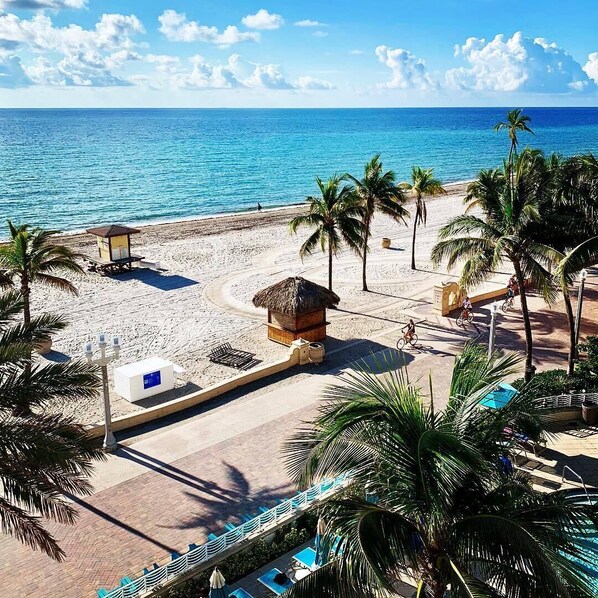 A beachside resort with a pool area, palm trees, and a lifeguard station. - Hollywood Beach Marriott (Hollywood)