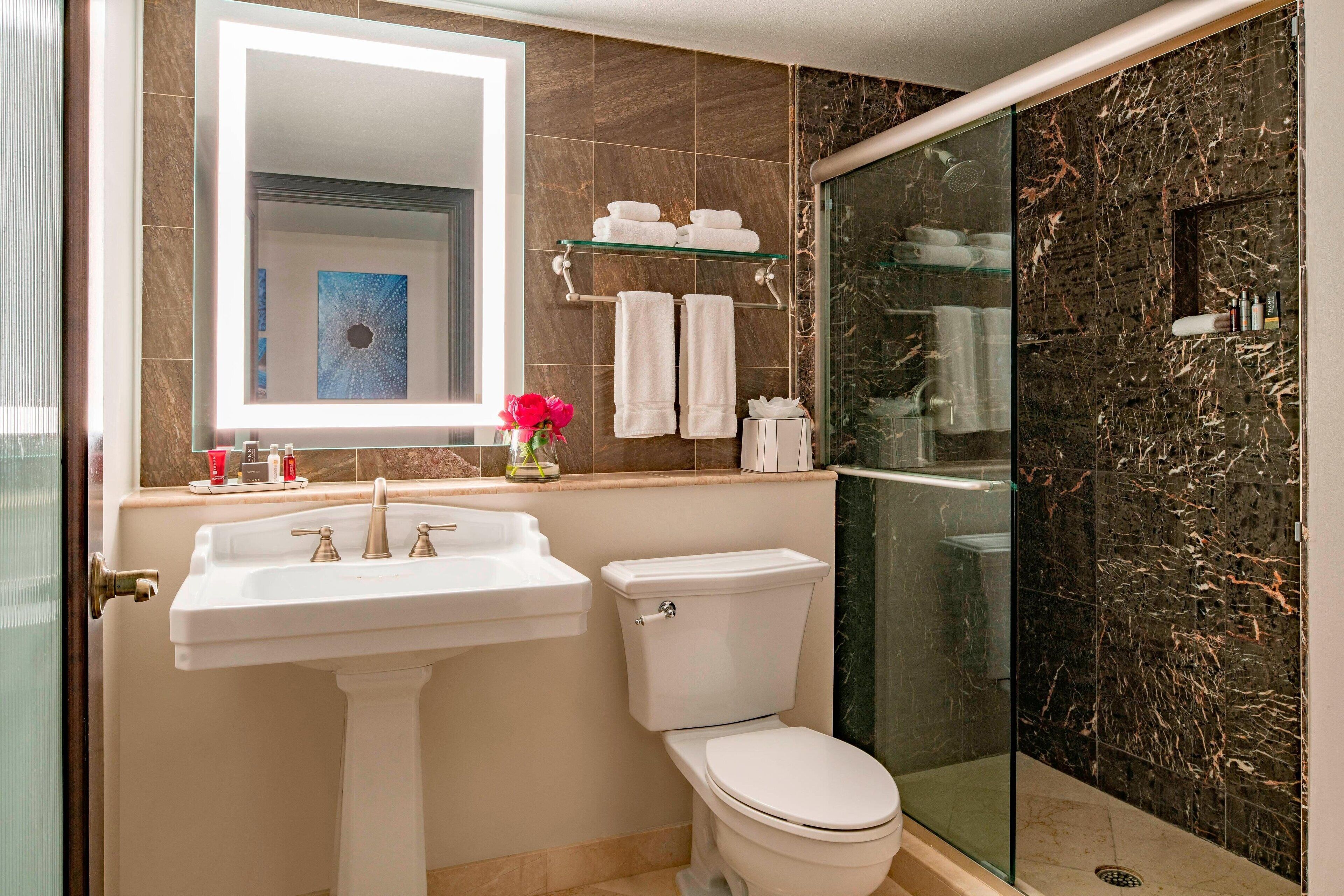 designer toiletries, hair dryer, towels